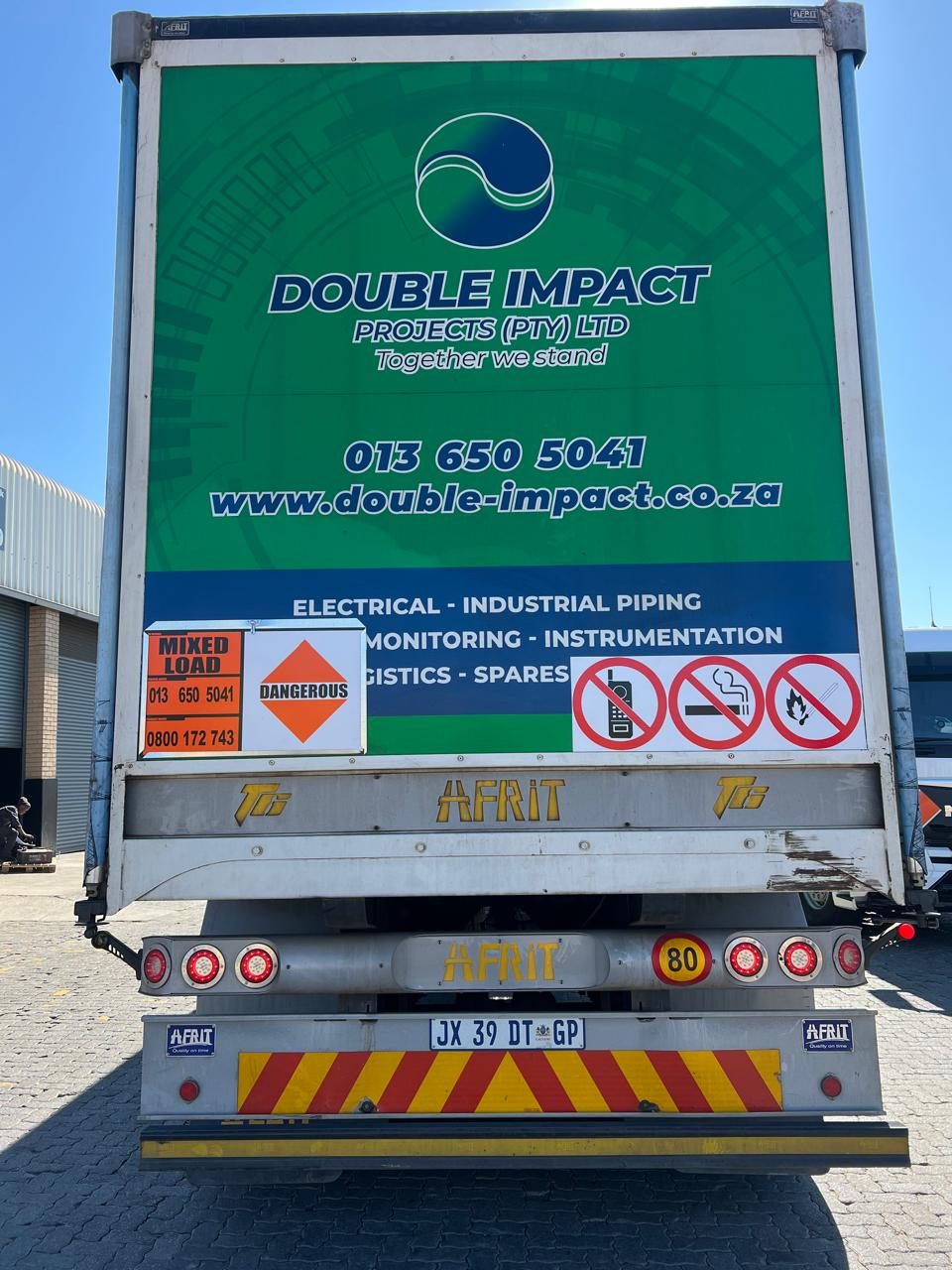 Double Impact Projects branded truck displaying the service offering